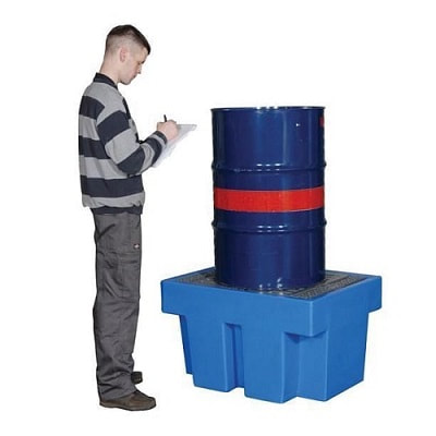 a man standing near spill pallet 1 drum